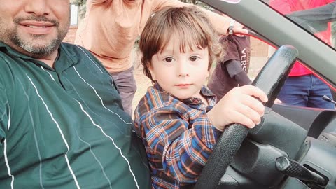 Cute baby is driving
