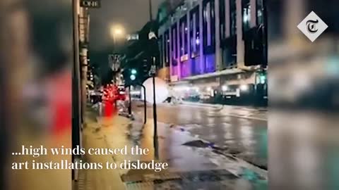 Cars dodge massive baubles rolling down central London street