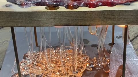 Dripping Molten Glass Over a Wooden Board With Holes