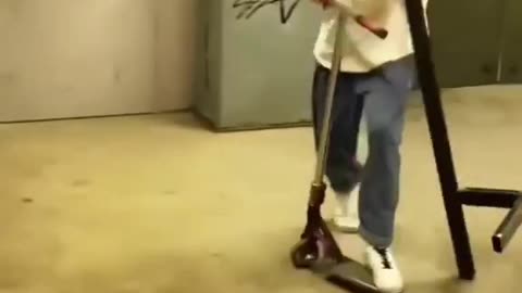 guy on a scooter grinds a pole and it filps up and hits him