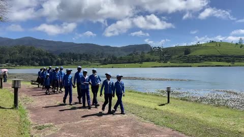 Sri Lankan schoolchildren walking by Gregory Lake, Nuwara Eliya, Sri Lanka