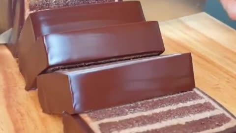 Elegant motion cuts through a multi-layered chocolate cake dessert