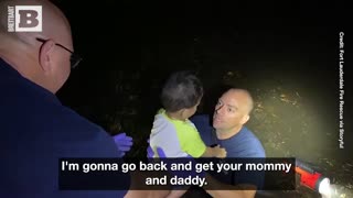 Fireman Braves High Water to Save Child from Flooded House