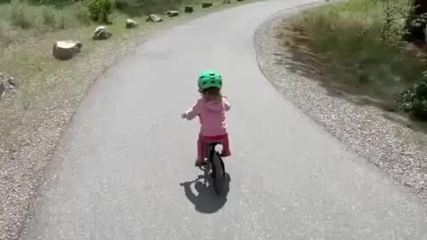 Baby Girl Riding A Bicycle