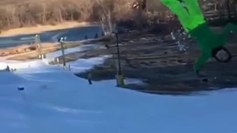 Guy bright green pants back flip ski