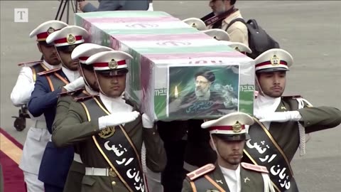 Coffin of Iranian president arrives in Tehran as thousands mourn