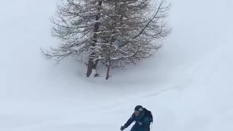 Skier does back flip but fails and face plants into snow