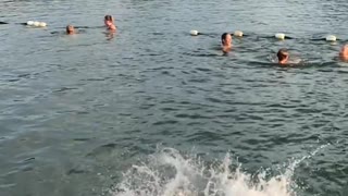 Little boy black shorts jump off dock slips