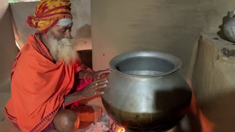 Dayalu Baba Preparing Hot Water for Devotees to Bathe