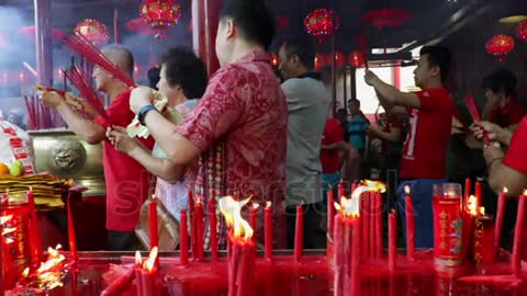 stock-footage-jakarta-indonesia-march-buddhist-people-praying-with-burning-incense-sticks-on-chinese