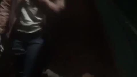 Guy scares girl in dark hallway and she falls backwards