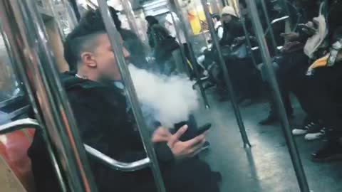 Guy brings hookah bong on subway train and smokes out of it