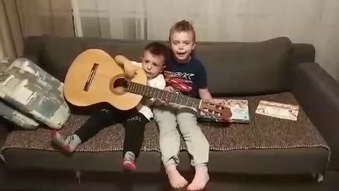 Little brother duo attempt to sing Spanish song