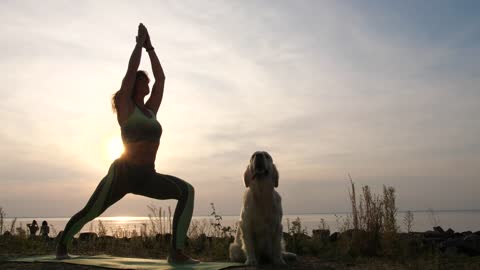 Woman doing Yoga at sunset