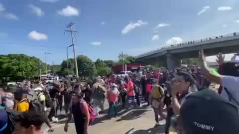 The migrant caravan has just overrun a roadblock set up by forces of the Mexican