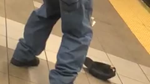Man bends over showing his buttcrack and scratches his butt, in subway station