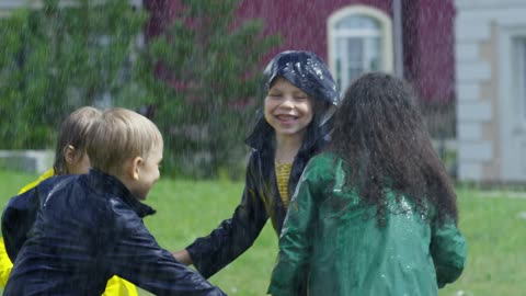 Children playing in rain, happy children, rain dance