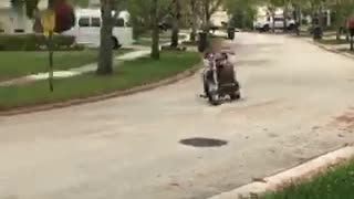 Red shirt motorcycle crashes into car parked on drive way