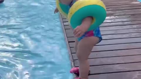 You will be stunned to see how a little girl is swimming in the water pool.