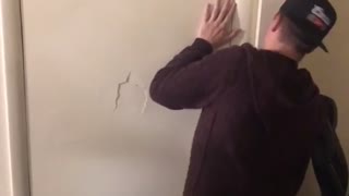 Guys block friend behind door arm punches hole through door