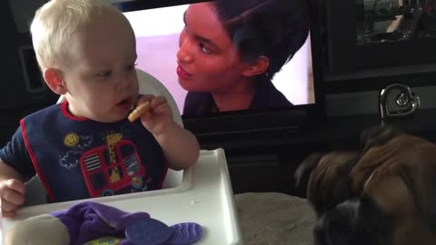 Baby's mind is completely blown after handing dog a cookie