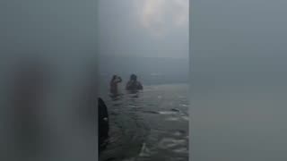 People wading in the harbor for hours escaping Maui fires