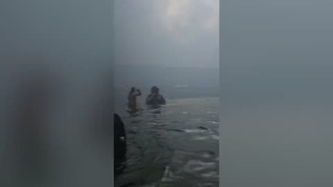 People wading in the harbor for hours escaping Maui fires