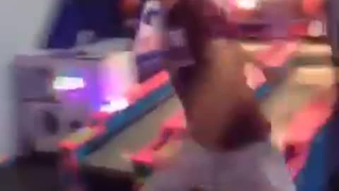 Guy tries to kick punching bag game falls on head in arcade
