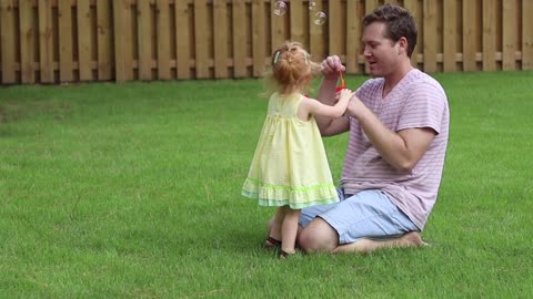 beautiful scene of father playing with daughter