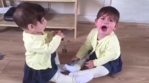 Twin baby girls fighting for car keys