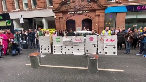 Protesters burn their electricity bills at the energy regulator in Glasgow,