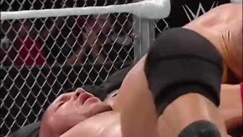 John Cena takes Randy Orton through a table with an Attitude Adjustment