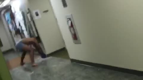 Guy punching wall with boxing gloves and making a hole