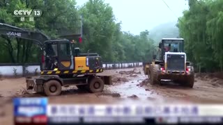 Flooding in central China damages embankment, swamps bridge