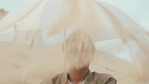 Man using Umbrella on Desert