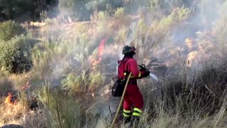 Firefighters battle to contain blaze in central Spain