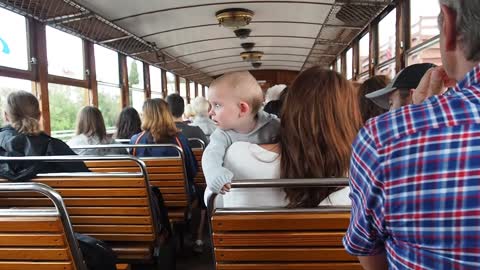 A cute baby sees a train for the first time