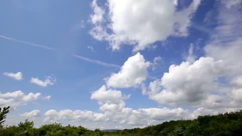 There are several white clouds floating in the sky