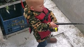 Son fishing with dad. Little boy fishing with dad.