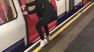 Woman pretends to stop train by pulling door