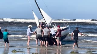 Beachgoers Work to Rescue Boat