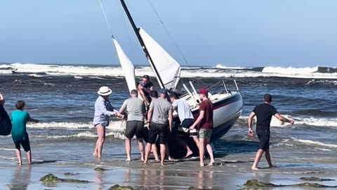 Beachgoers Work to Rescue Boat