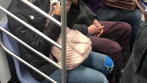 Man brushes his teeth on subway train