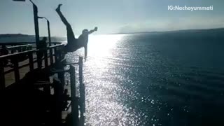 Man jumps off pier and lands on his side