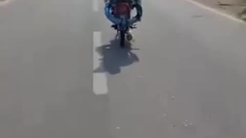 An old man is driving a motorbike without a handle