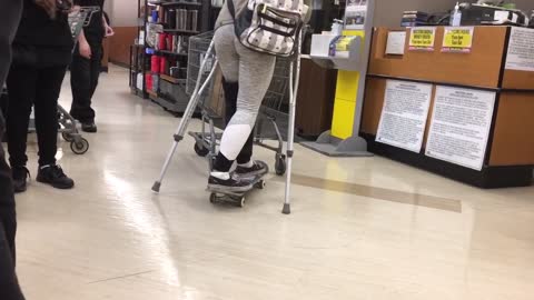 Woman on crutches uses skateboard to push shopping cart