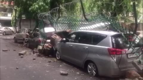 School Walls Crippled by Heavy Rains Crush Parked Cars