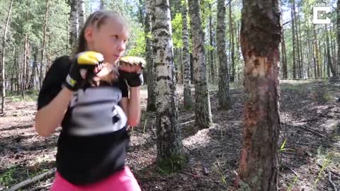 Teen girl punches down a tree using boxing skills