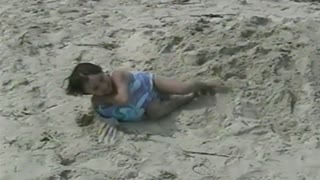 Little Girl Fills Bathing Suit With Sand