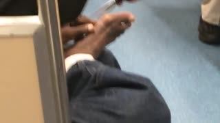 Man using scissors on his bare feet